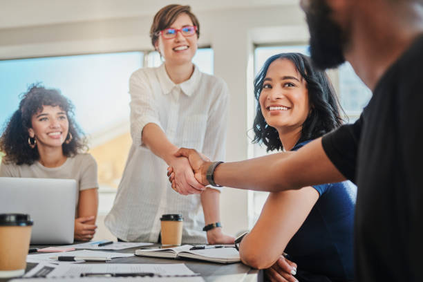 Handshake, partnership deal and teamwork success in digital marketing office support, global trust or b2b business people meeting. Smile, happy or welcome gesture for creative tech crm collaboration